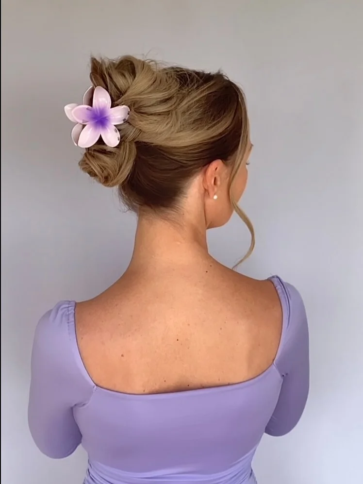 best summer easy hairstyle 2026 Romantic Twisted Bun with Floral Clip