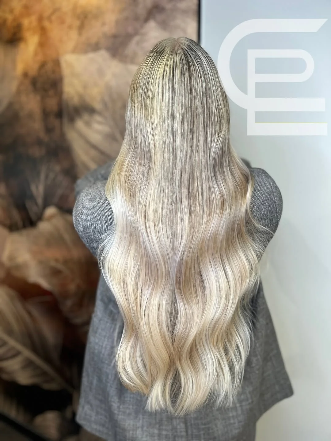 feathered summer haircuts for long hair 2026 Soft Platinum Feathered Waves with Cool Shine