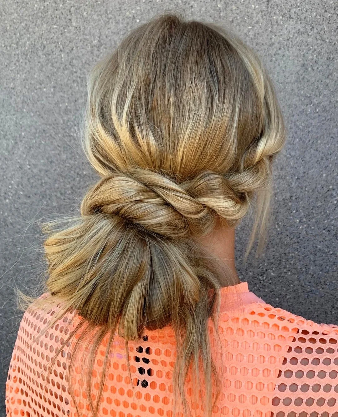 flattering summer hairstyles ideas 2026 Soft Twisted Low Bun with Textured Finish