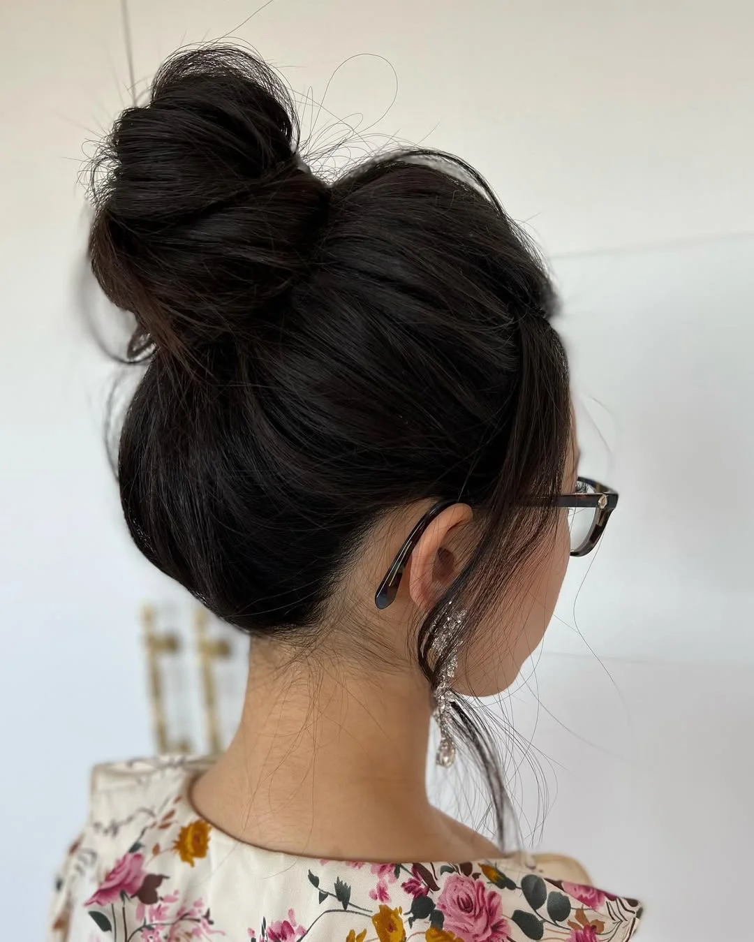 flattering summer hairstyles ideas 2026 Chic Twisted High Bun with Soft Face Framing Pieces