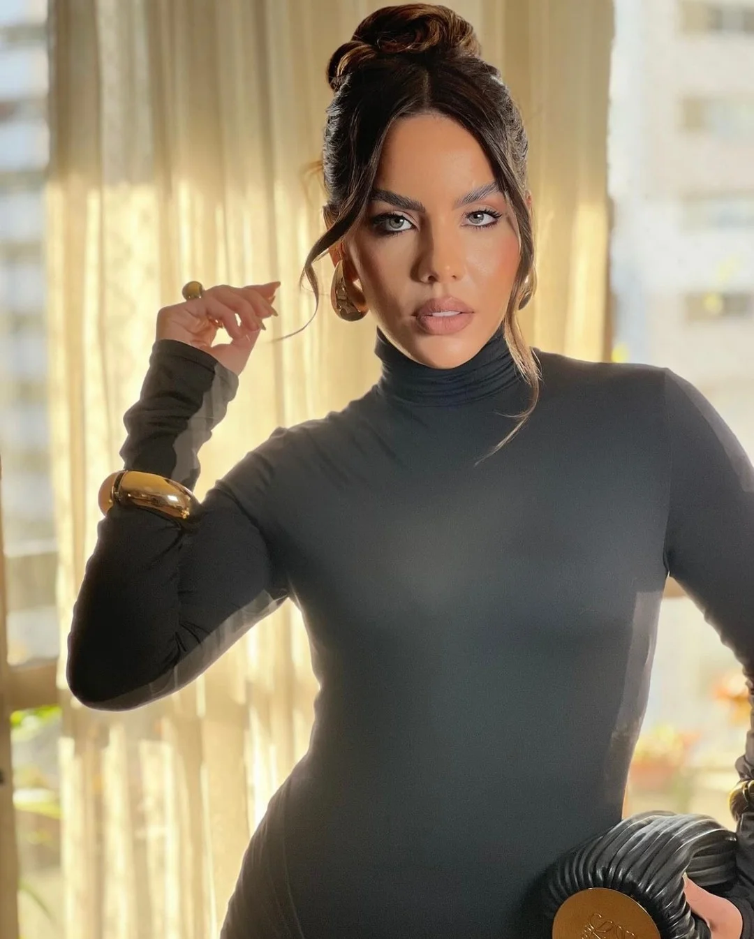 flattering summer hairstyles ideas 2026 Sleek High Bun with Face-Framing Tendrils