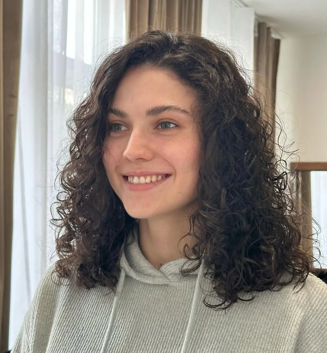 gorgeous summer haircut for round face 2026 Curly Medium Length Cut with Natural Volume Balance