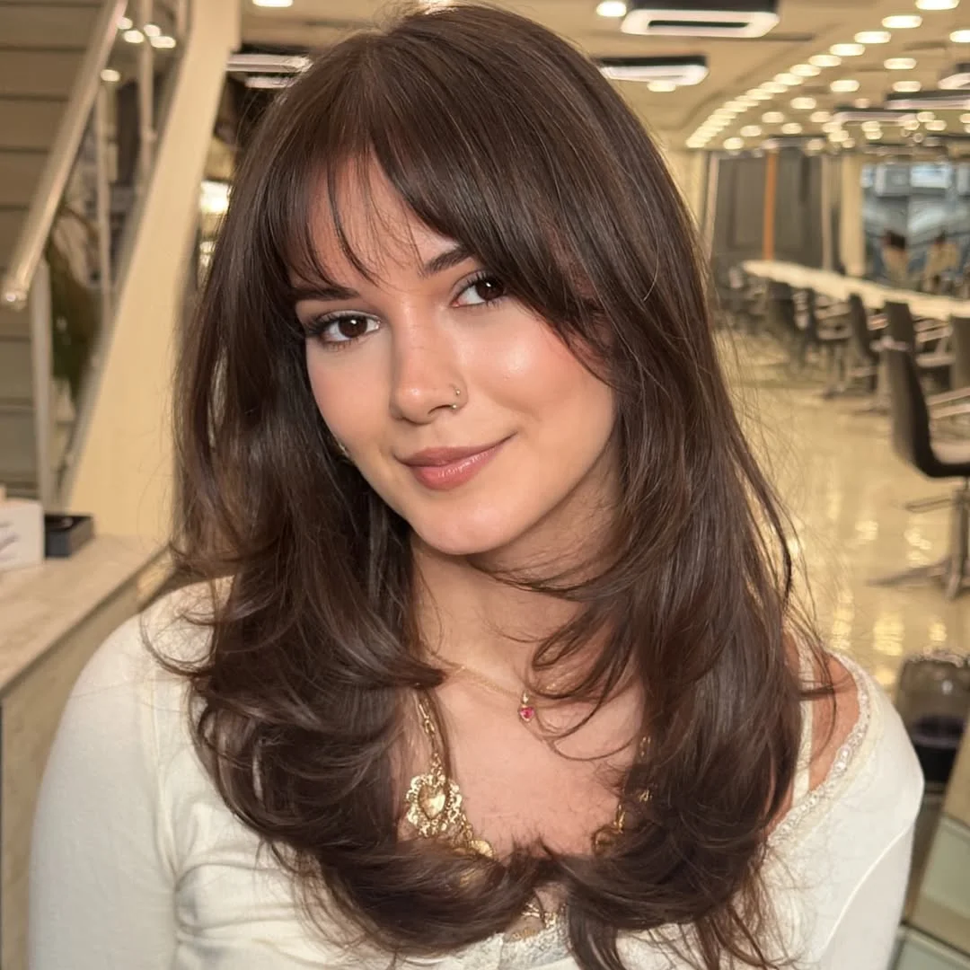 gorgeous summer haircut for round face 2026 Soft Voluminous Layers with Wispy Bangs