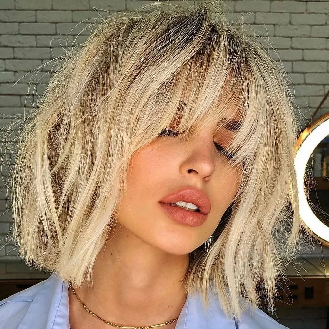sassy summer short hairstyles 2026 Shaggy Blonde Bob with Airy Bangs