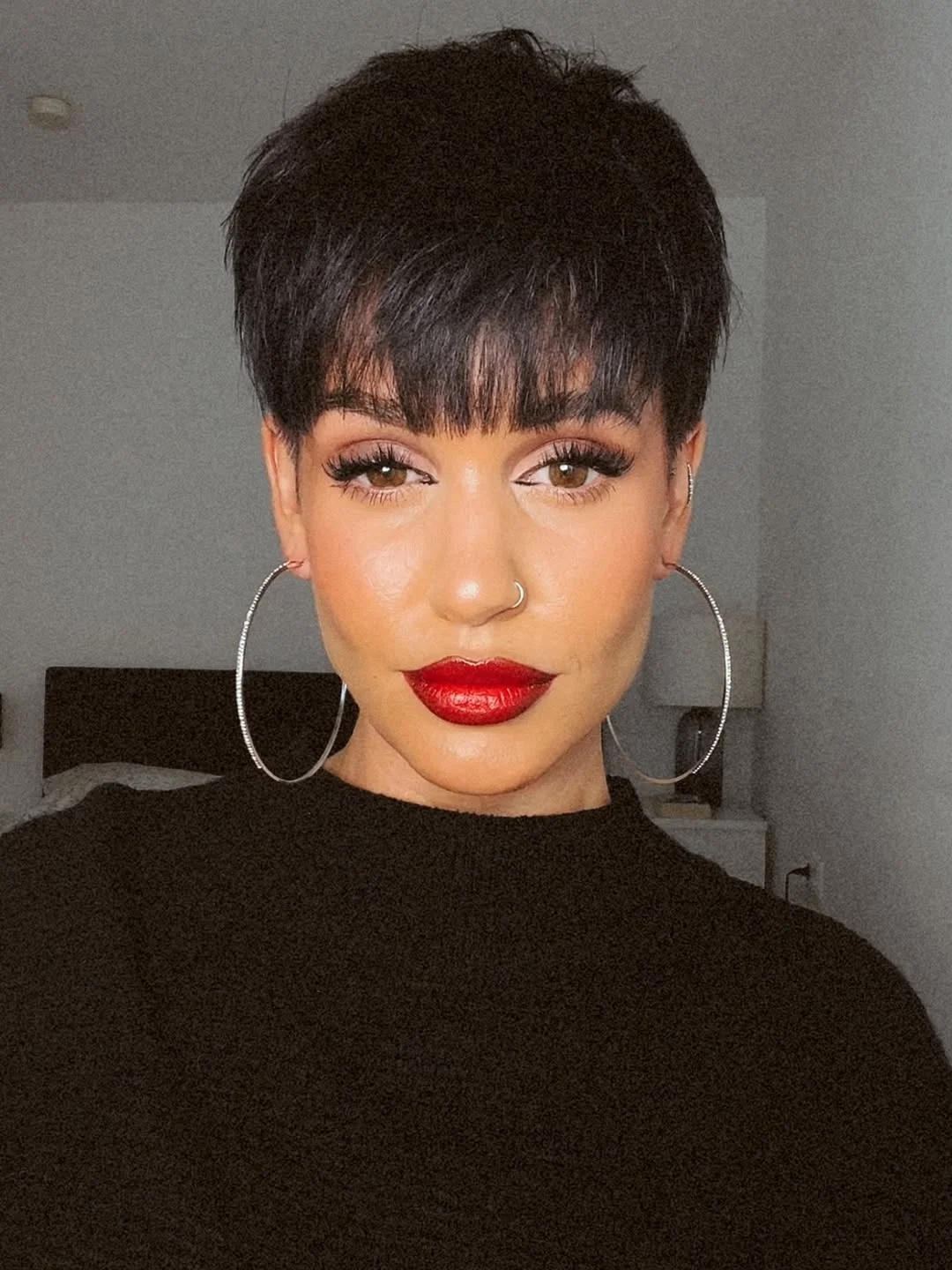sassy summer short hairstyles 2026 Sharp Brunette Pixie with Defined Bangs and Glossy Finish
