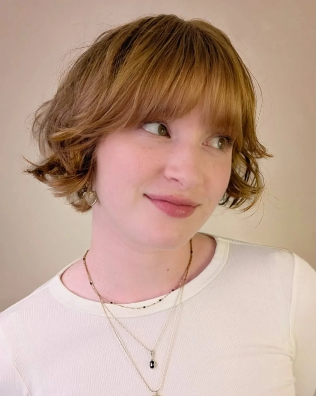 sassy summer short hairstyles 2026 Soft French Bob with Wispy Bangs and Warm Dimension