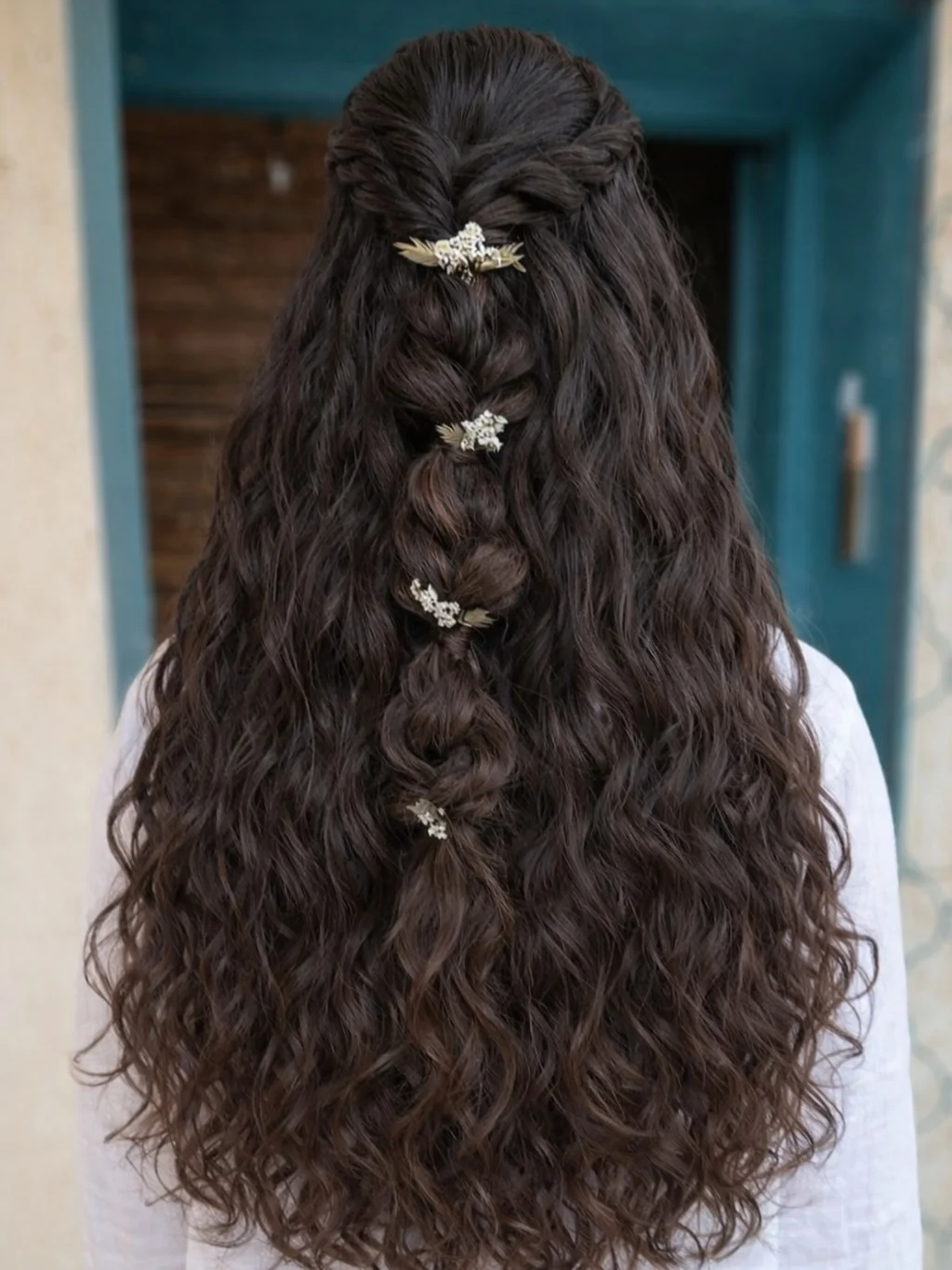 boho summer wavy hairstyle 2026 Deep Brunette Cascading Waves with Statement Boho Braid