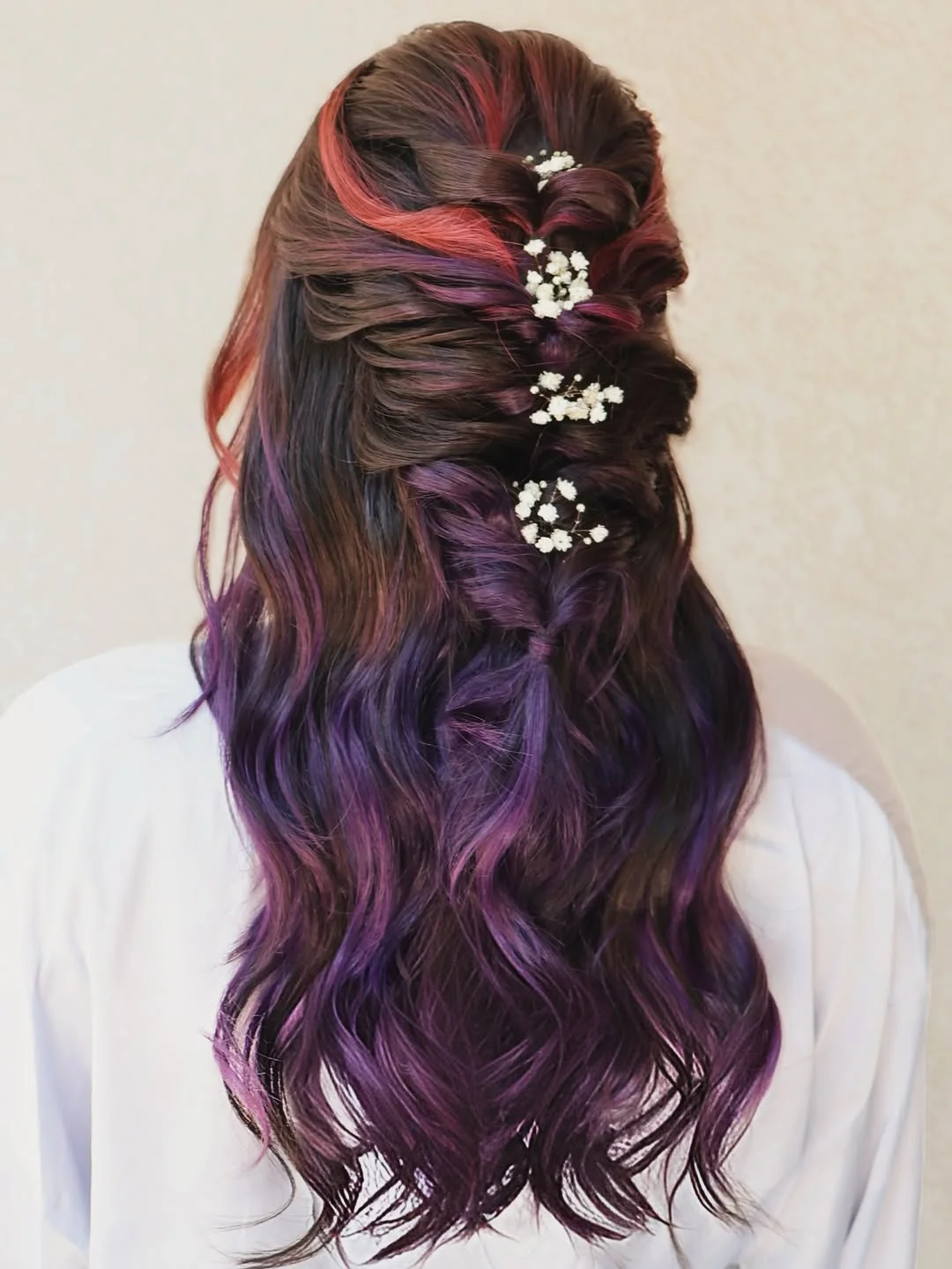 boho summer wavy hairstyle 2026 Multi Tone Burgundy Waves with Floral Braided Accent