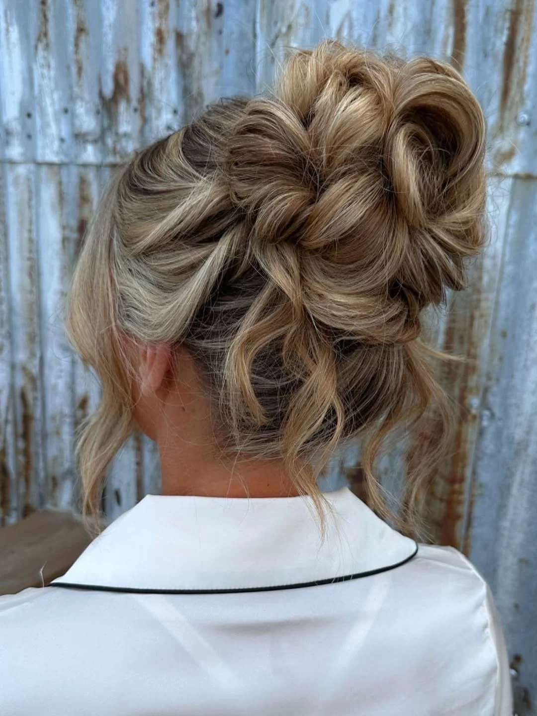 boho summer wavy hairstyle 2026 Loose Blonde Boho Bun with Braided Texture