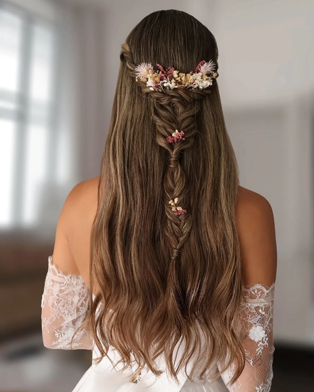 boho summer wavy hairstyle 2026 Soft Brunette Length with Minimalist Floral Braid Detail