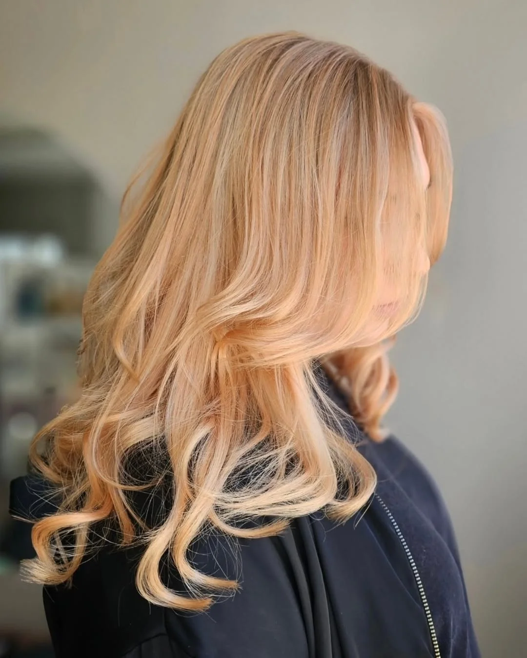bright summer apricot blonde hair color 2026 Buttercream Apricot Blonde with Soft Glam Curls