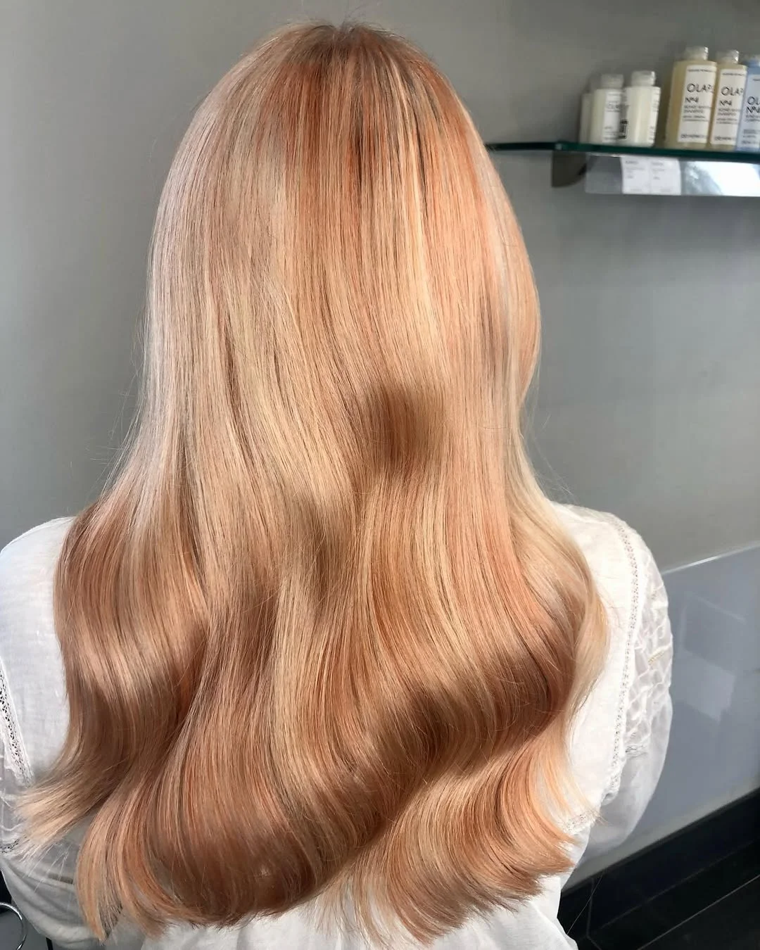 bright summer apricot blonde hair color 2026 Muted Peach Blonde with Soft Golden Contouring