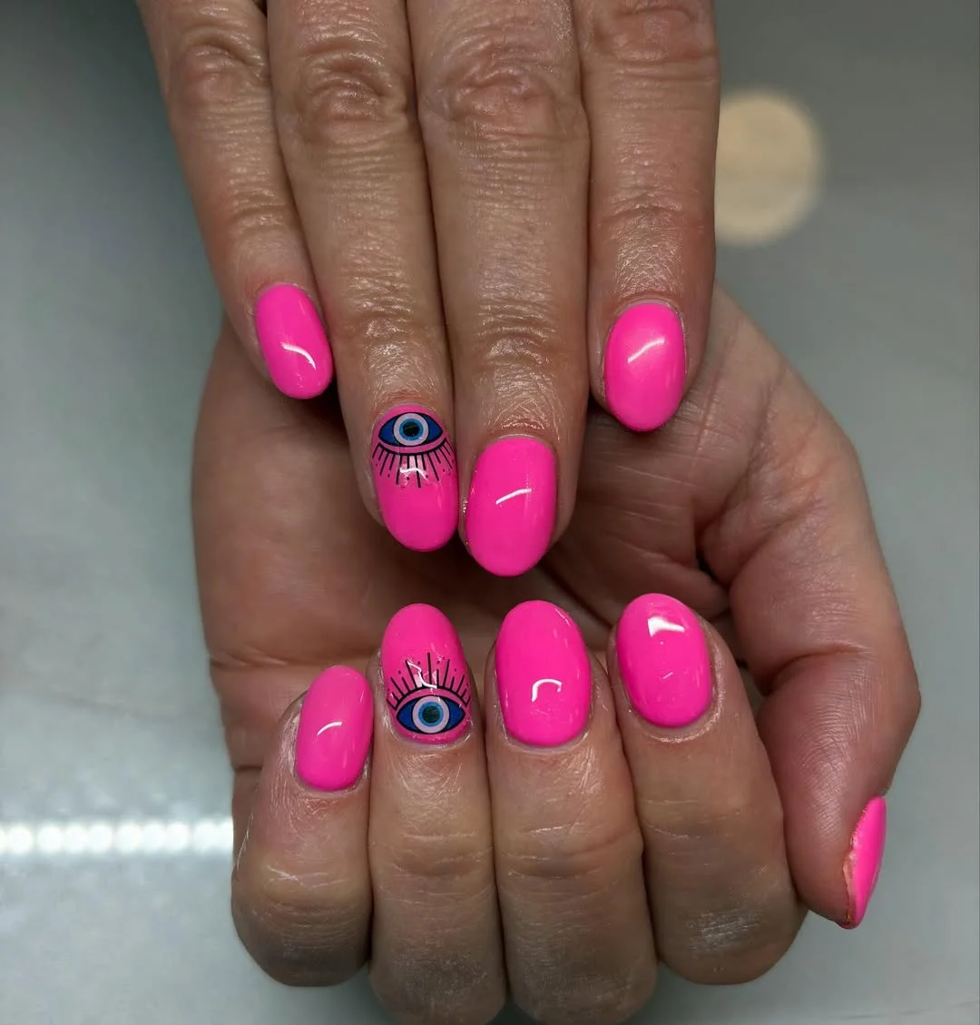 bright summer nails 2026 Hot Pink Evil Eye Nails With a Playful Twist