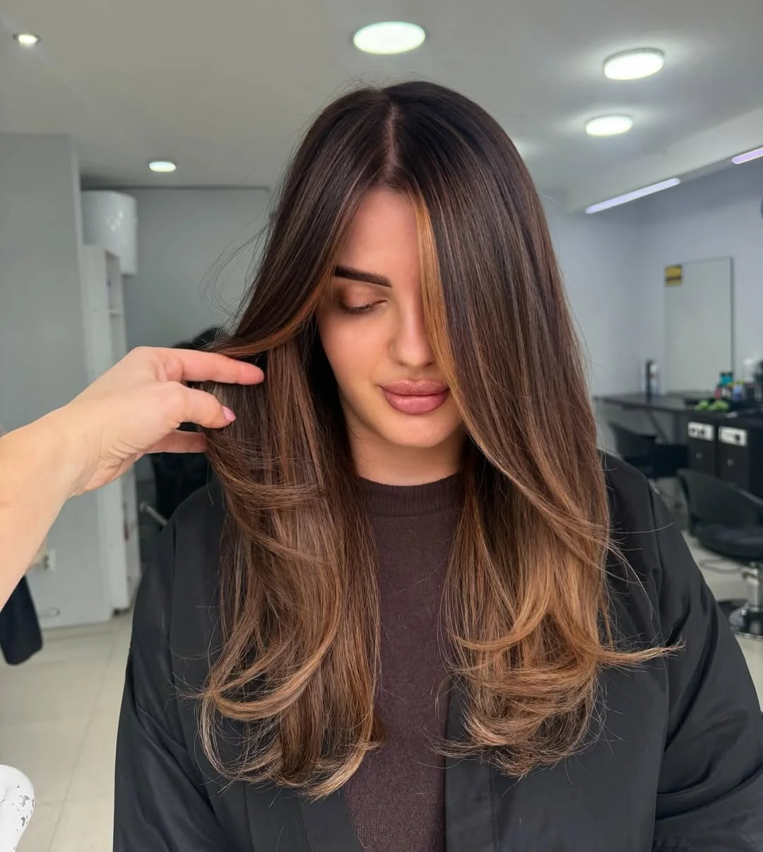 glossy summer hair color for brown skin 2026 Warm Cocoa Ribbons With Soft Caramel Framing