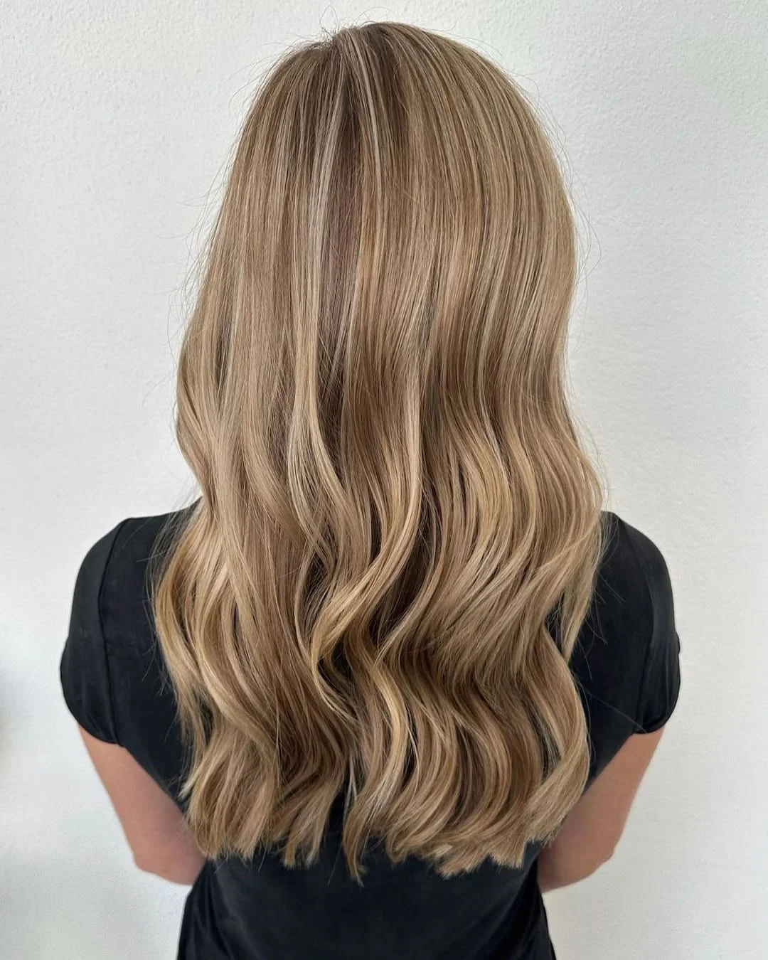 light summer honey blonde hair color 2026 Muted Honey Beige Waves with Natural Depth