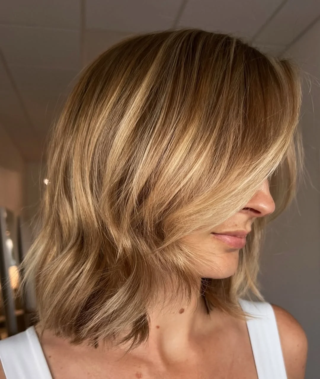light summer honey blonde hair color 2026 Textured Honey Lob with Light Catching Ends