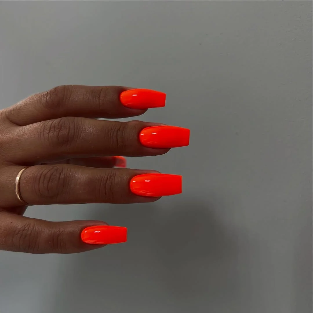 light summer nails 2026 Electric Neon Orange Nails That Glow Against Sun-Kissed Skin