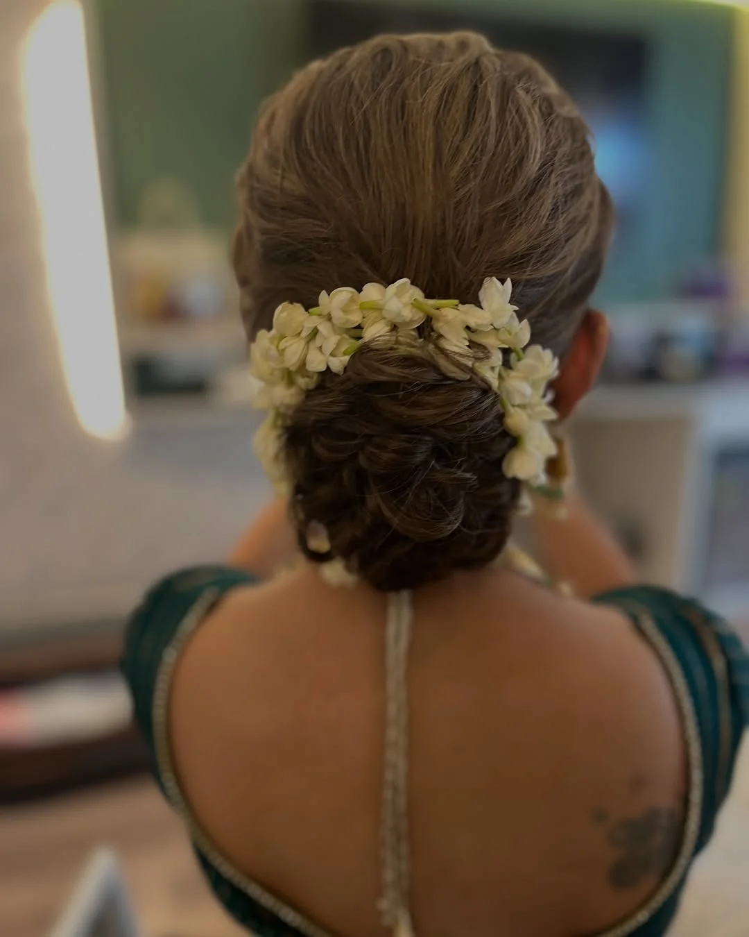 quick summer bun hairstyles 2026 Fresh Jasmine-Inspired Low Bun For Humid Summer Nights