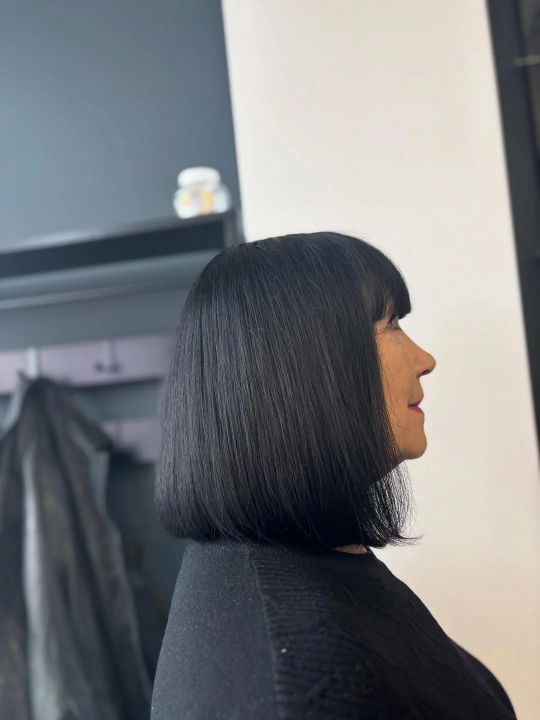 refined summer haircuts for women over 60 2026 Sharp Black Bob With Graphic Summer Elegance