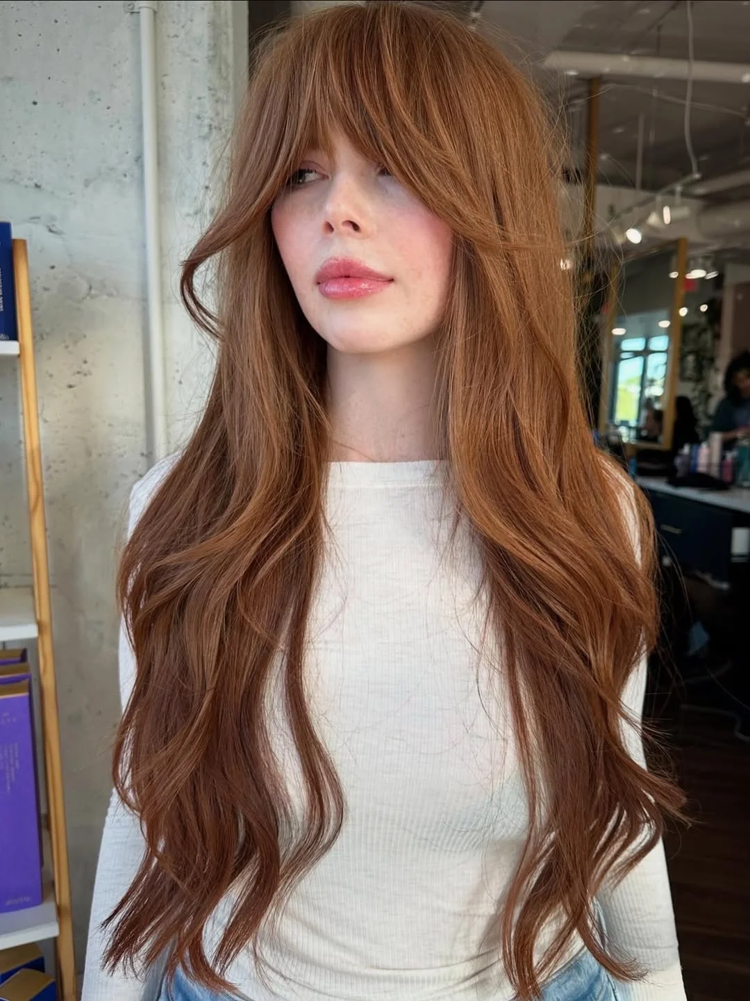 salon summer haircuts with bangs 2026 Long Cinnamon Waves With Feathered Bardot Bangs