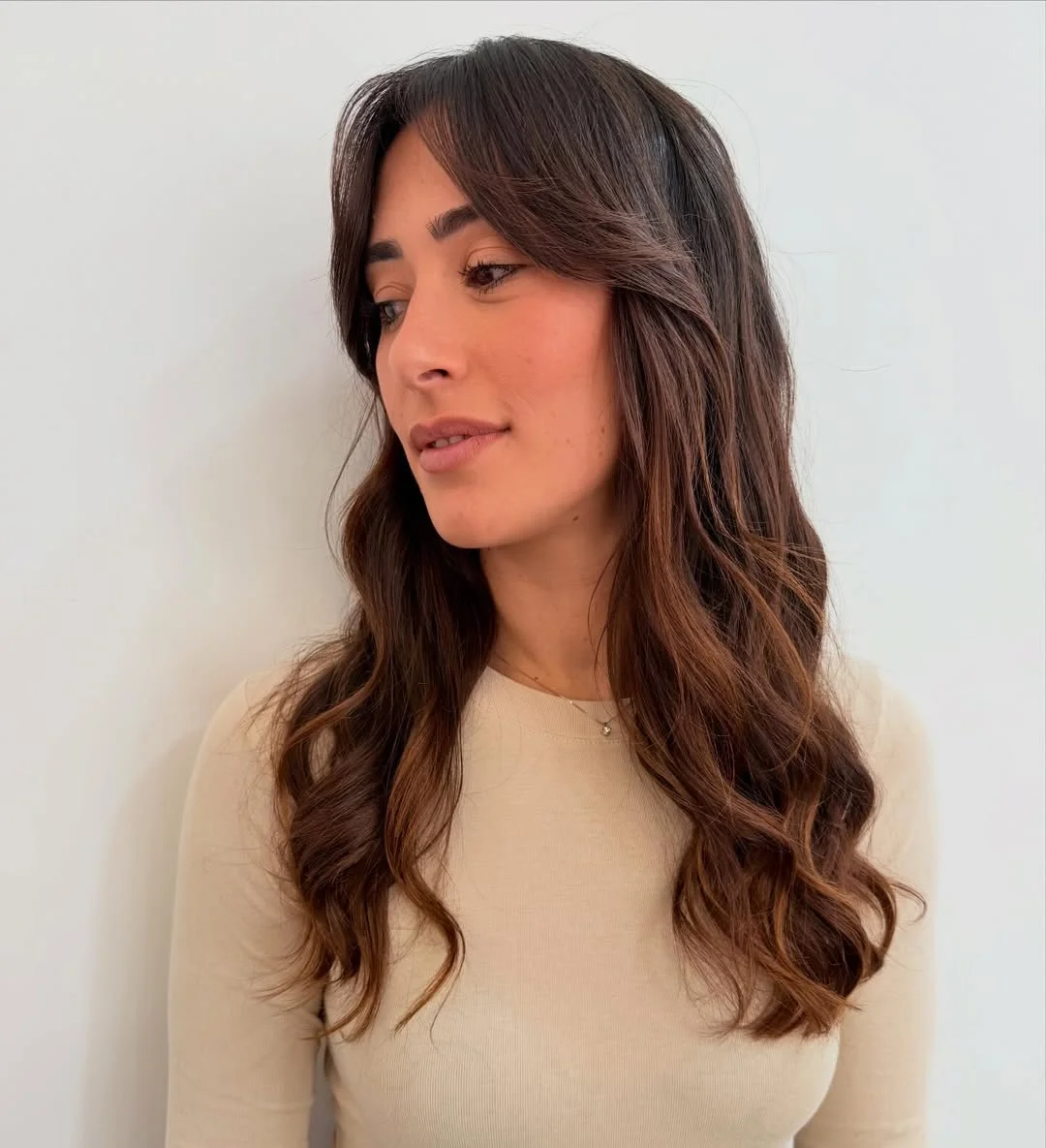 salon summer haircuts with bangs 2026 Loose Brunette Waves With Relaxed Curtain Bangs