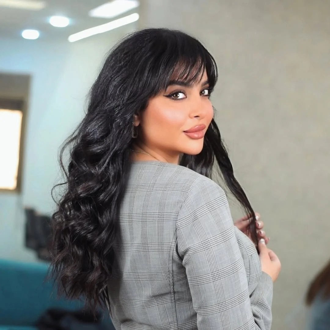 salon summer haircuts with bangs 2026 Glossy Midnight Waves With Flirty Wispy Bangs