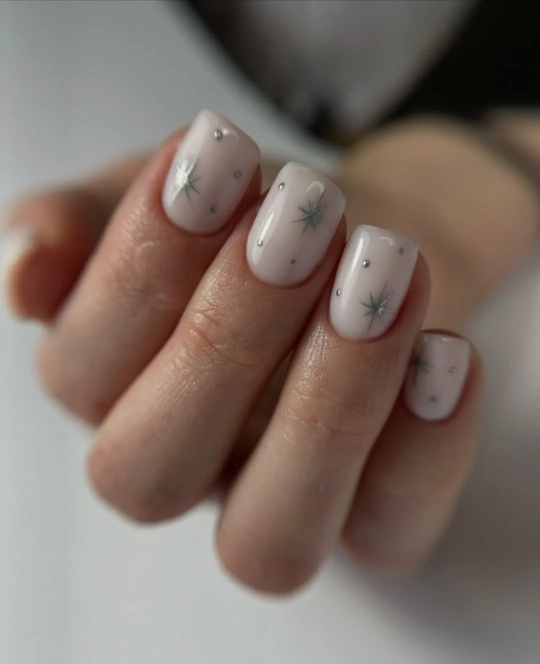 short squoval nails design 2026 Soft Winter Star Details on a Milky White Base