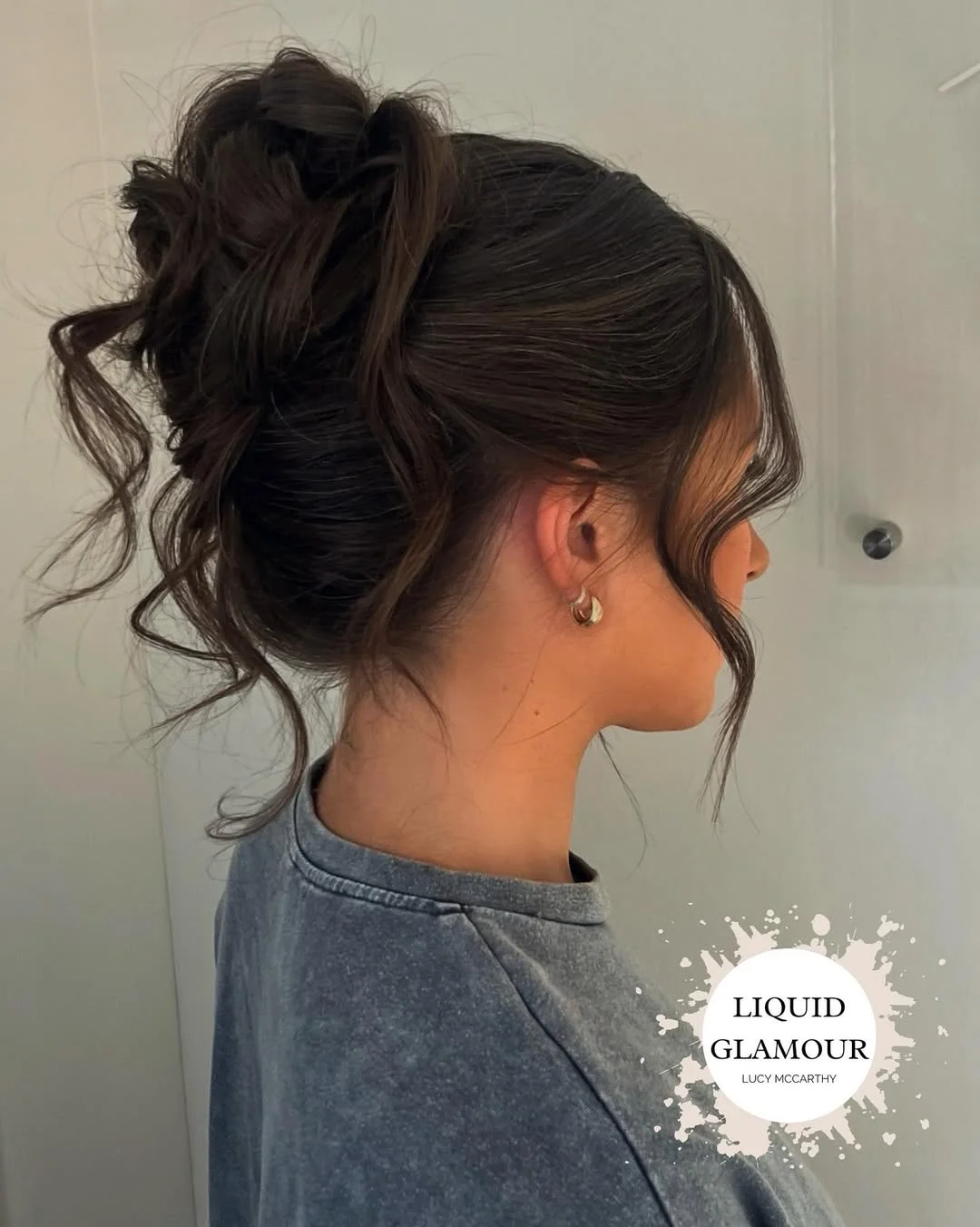 stylish summer updo hairstyles 2026 Soft Curly High Bun With Romantic Face-Framing Pieces