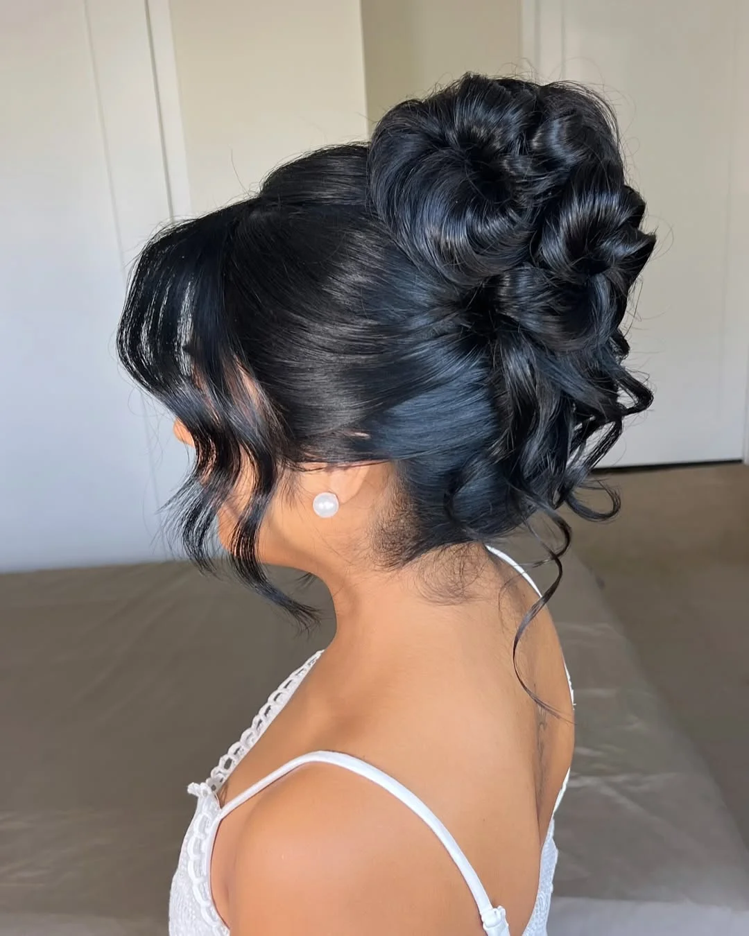 stylish summer updo hairstyles 2026 Glossy Black Curly Updo With Soft Romantic Volume