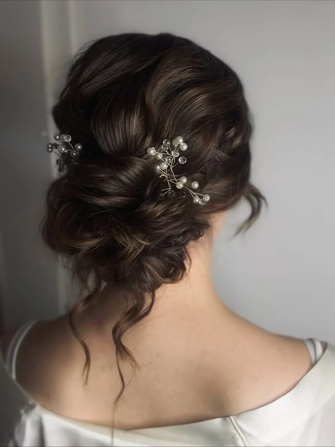 stylish summer updo hairstyles 2026 Soft Bridal-Inspired Low Bun With Pearl Accessories