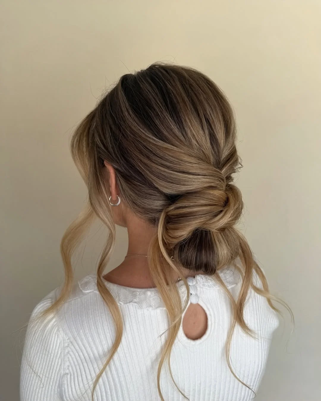 stylish summer updo hairstyles 2026 Low Twisted Bun With Soft Blonde Dimension