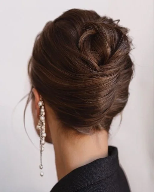 stylish summer wedding guest hairstyles 2026 Soft Twisted Chignon for Elegant Summer Evenings