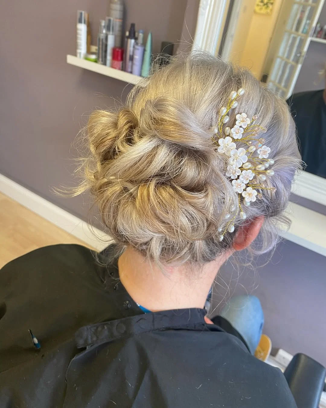stylish summer wedding guest hairstyles 2026 Textured Floral Updo with Romantic Pearl Details