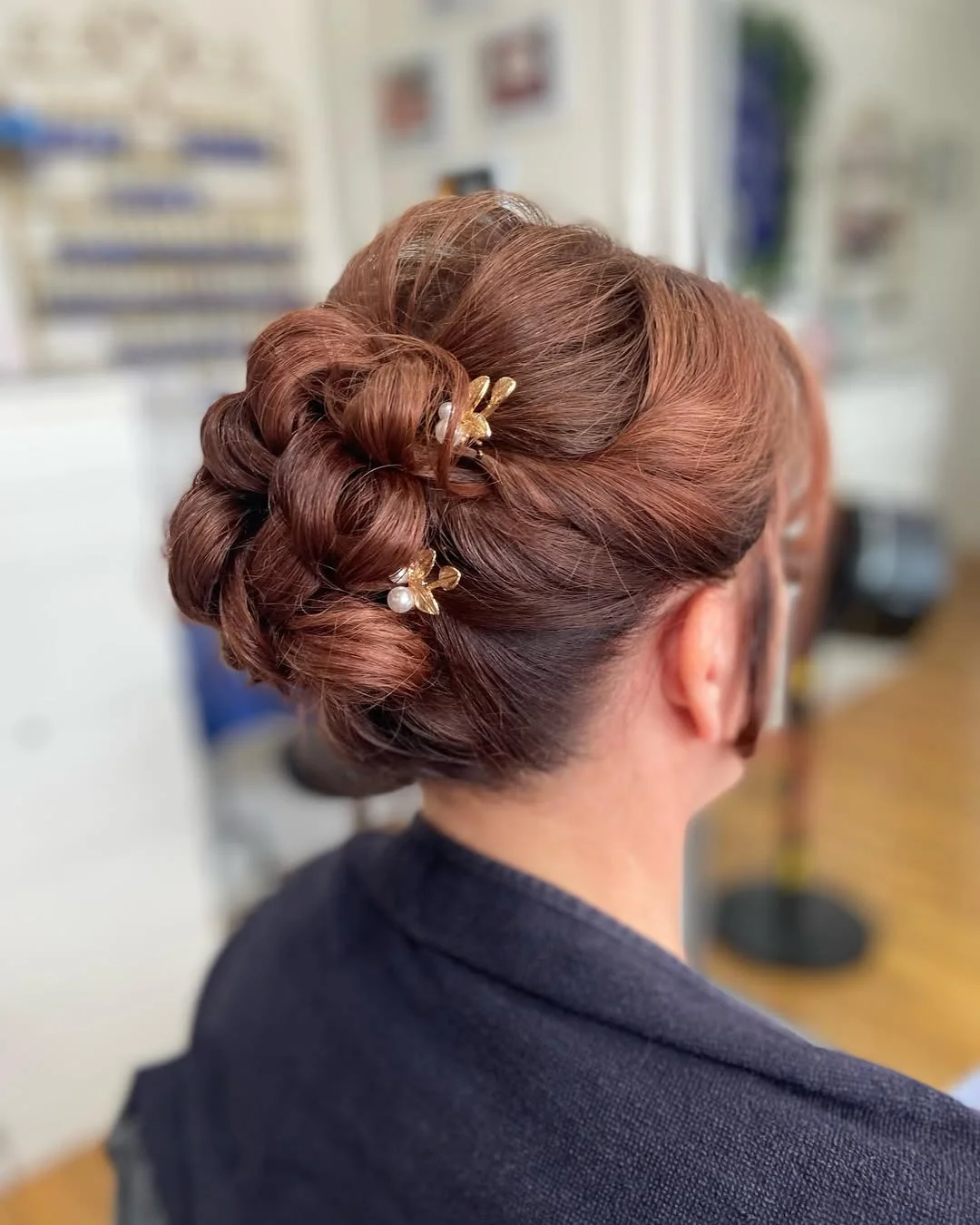 stylish summer wedding guest hairstyles 2026 Elegant Auburn Chignon with Delicate Gold Accents
