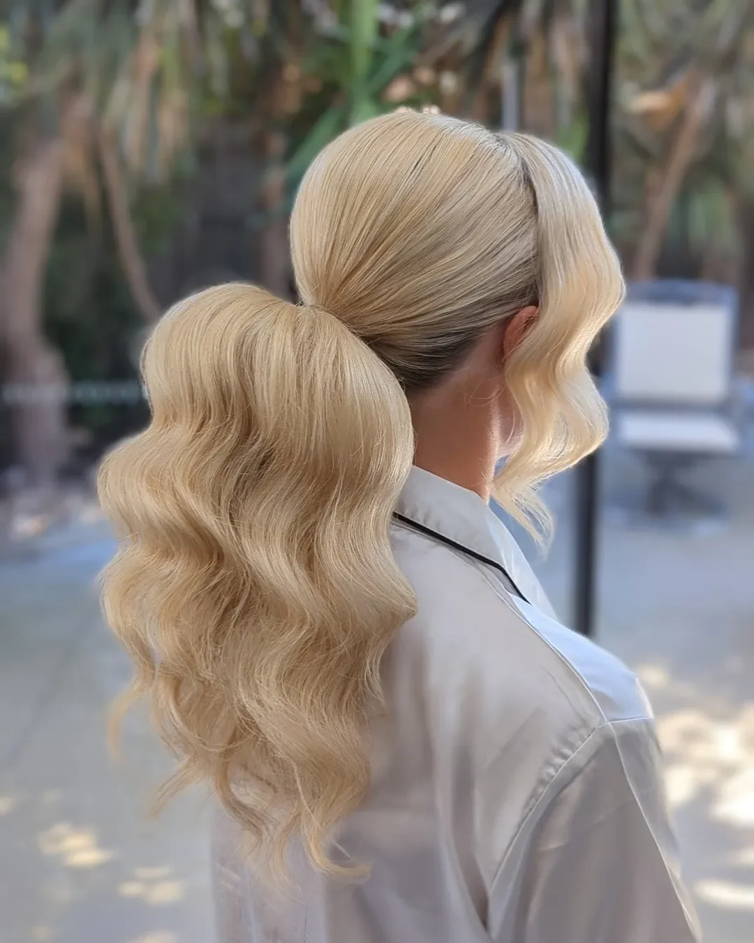 stylish summer wedding guest hairstyles 2026 Voluminous Blonde Ponytail with Glamorous Retro Waves