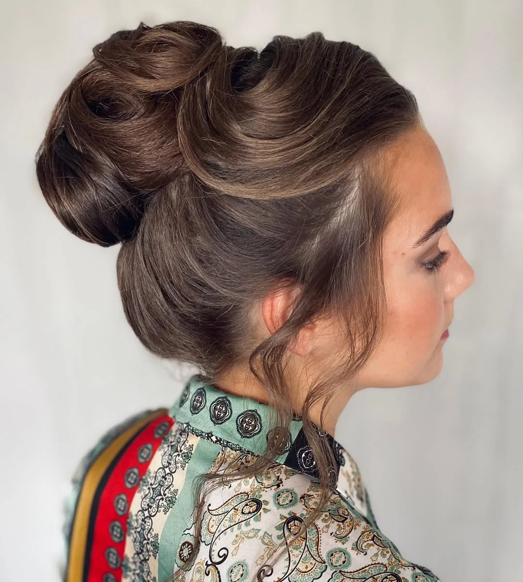 stylish summer wedding guest hairstyles 2026 Voluminous Sculpted Bun with Soft Romantic Texture