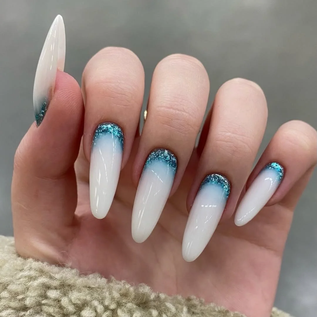 summer manicure color ideas 2026 Milky White Almond Nails With Ocean Blue Glitter