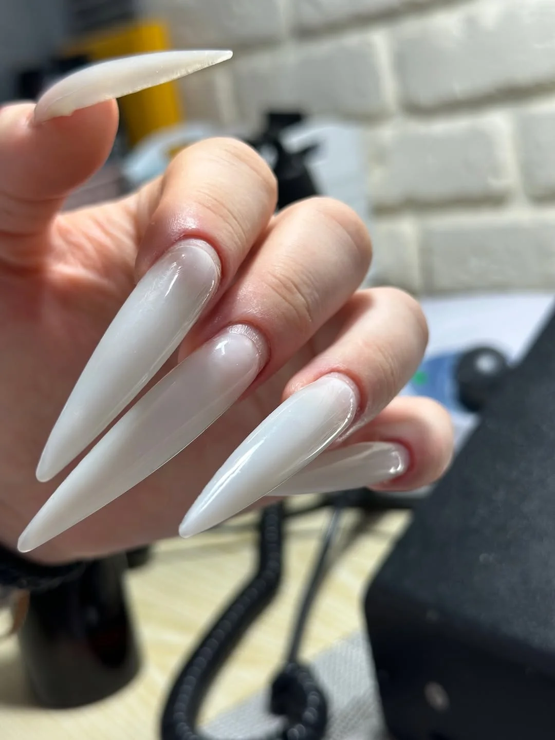 summer manicure color ideas 2026 Milky White Stiletto Nails With a Cloud-Like Finish