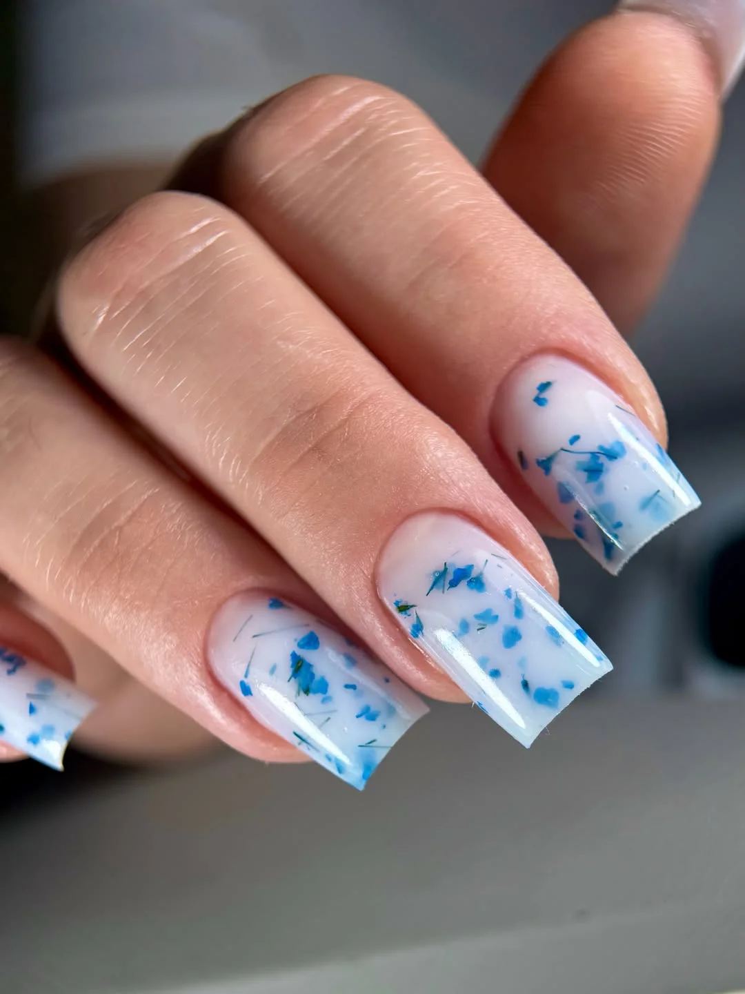 summer nail colors 2026 Blue Floral Confetti Nails With Soft Milky Bases