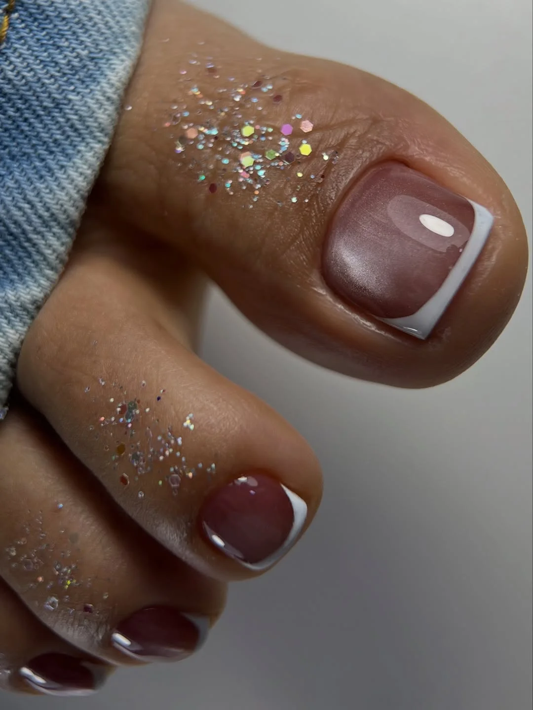 summer toe nails colors 2026 Glossy Nude French Toes With a Subtle Pearl Finish