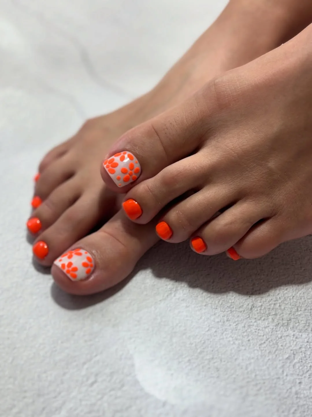summer toe nails colors 2026 Neon Orange Floral Toes for Playful Vacation Energy