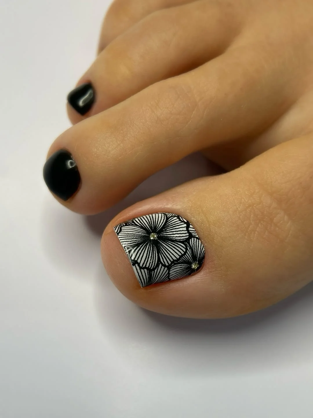 summer toe nails colors 2026 Black Floral Pedicures That Feel Bold and Editorial