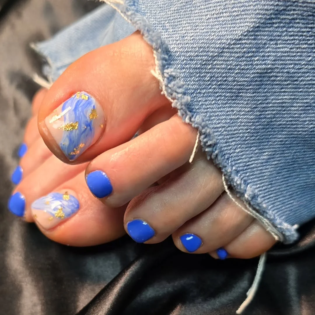 summer toe nails colors 2026 Ocean Blue Marble Toes With Gold Foil Details