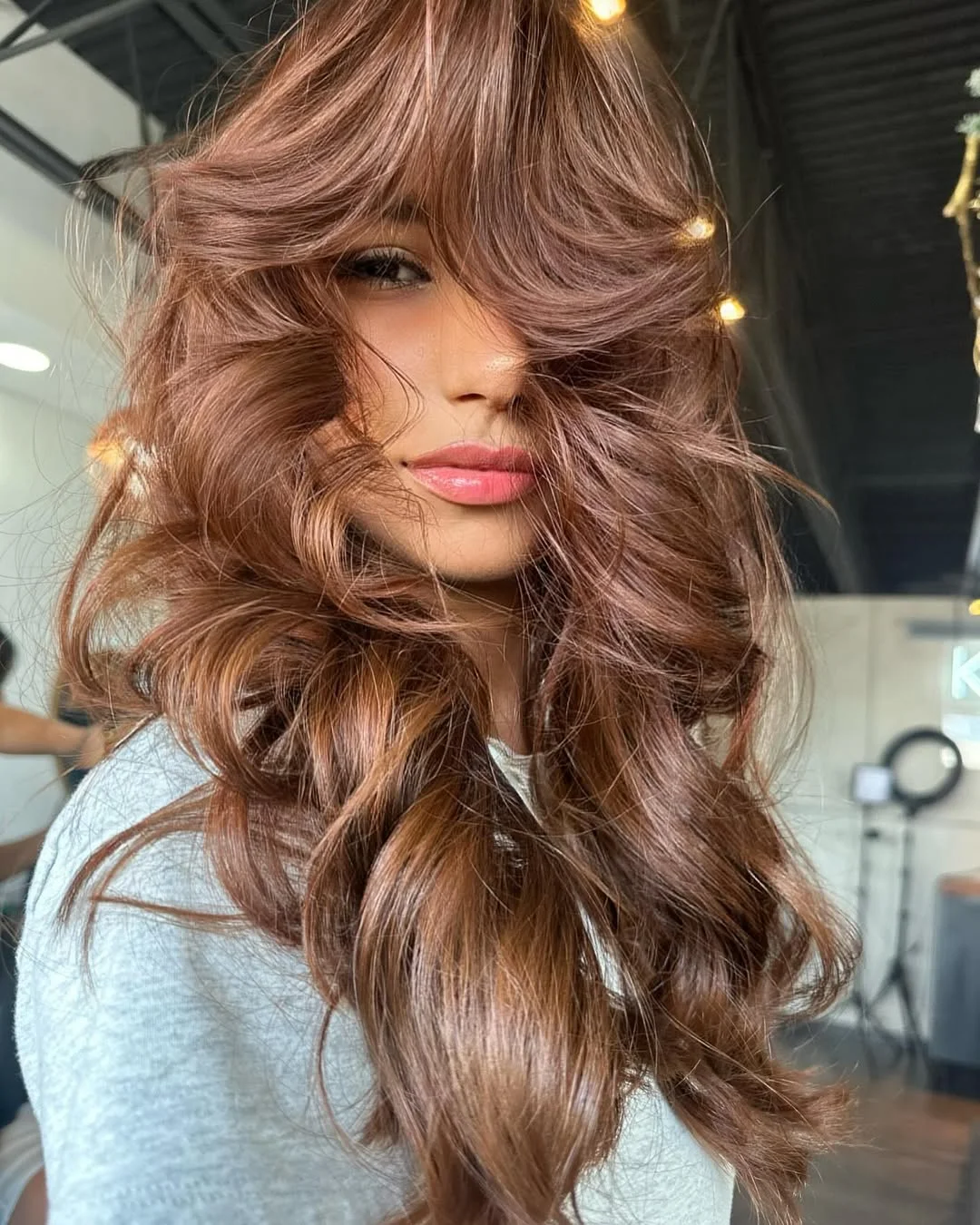 sun-kissed summer auburn hair color 2026 Soft Layered Auburn with Voluminous Curtain Bangs
