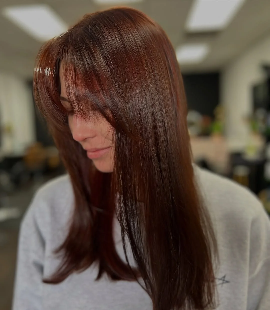 sun-kissed summer auburn hair color 2026 Sleek Auburn Layers with Feathered Fringe