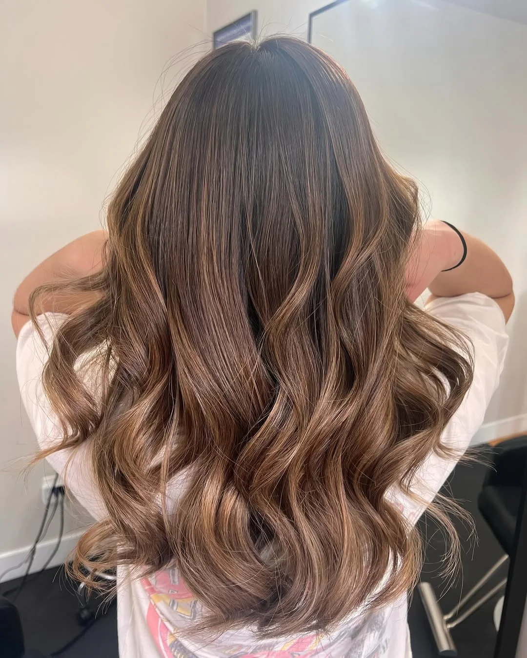 toffee summer hair color for tan skin 2026 Creamy Toffee Brunette With Glossy Summer Waves