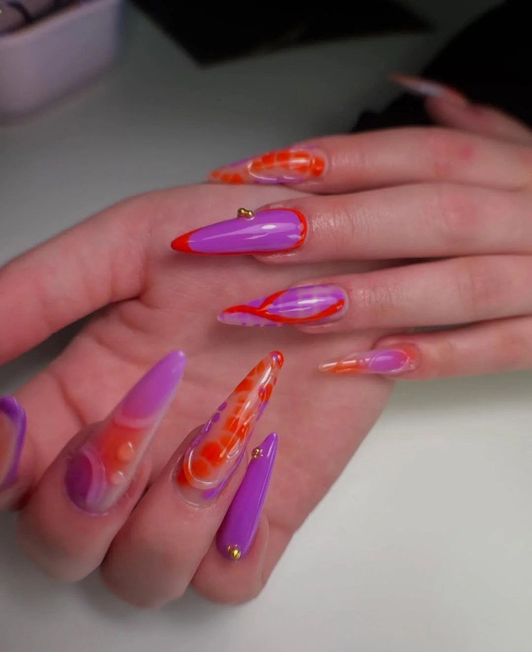 trendy summer nails 2026 Neon Lavender and Orange Swirl Nails for a Statement Summer