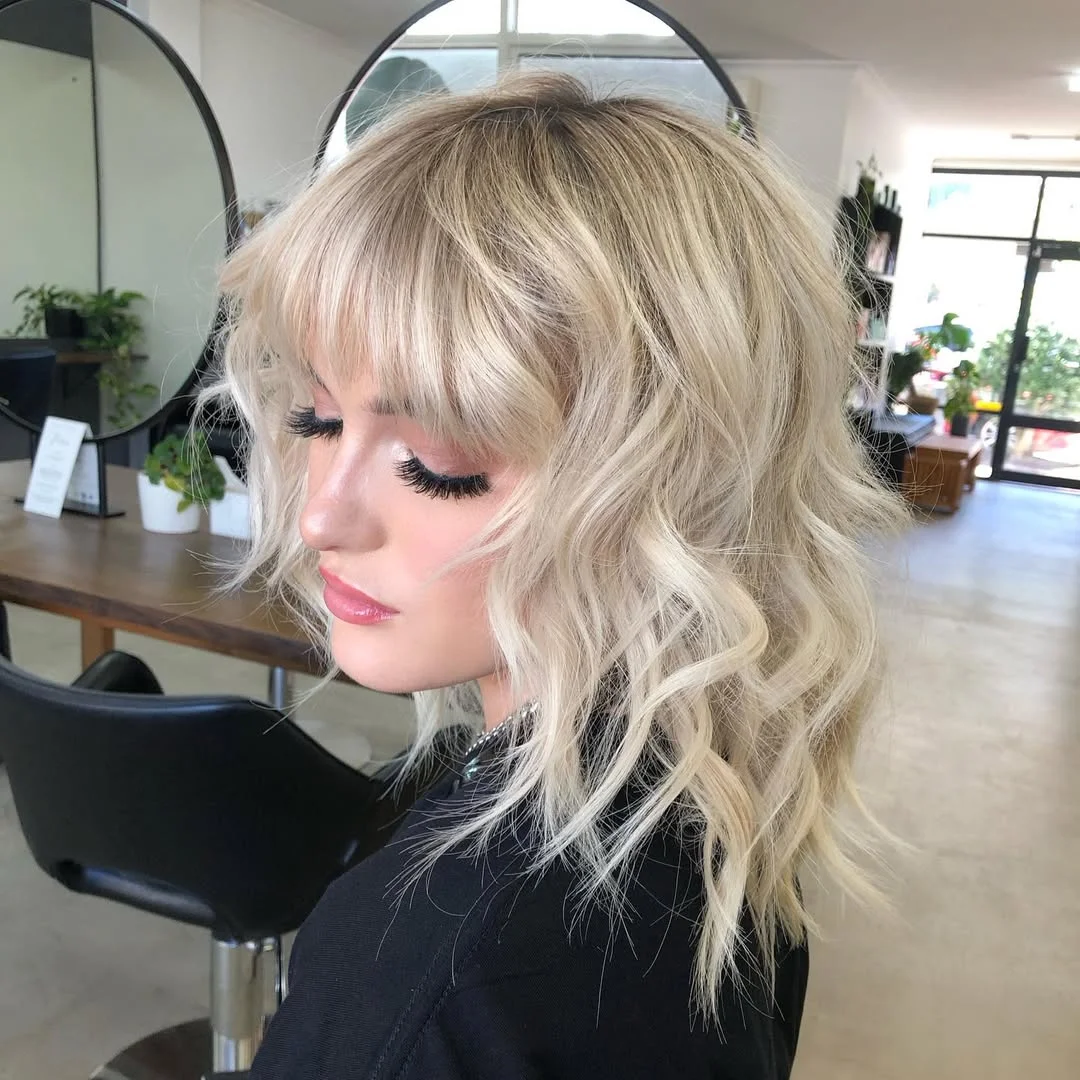 voluminous summer shag hairstyle 2026 Retro Feathered Shag with Color Contrast