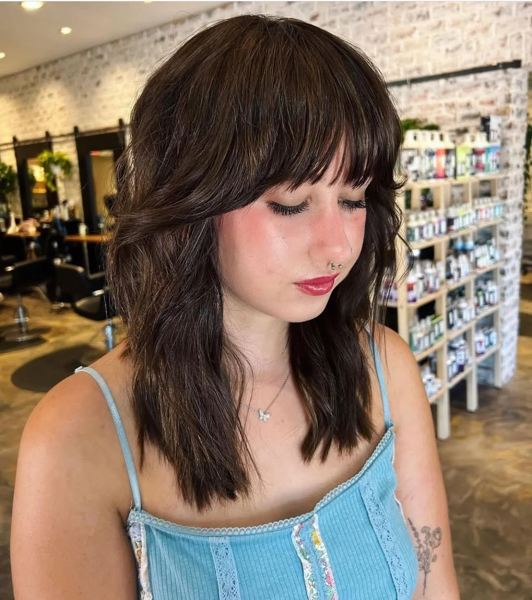 voluminous summer shag hairstyle 2026 Textured Medium Shag with Wispy Bangs
